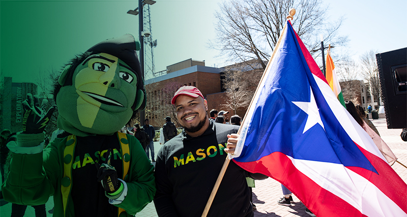 A Ƶ student poses with the Patriot, Mason's mascot, during International Week