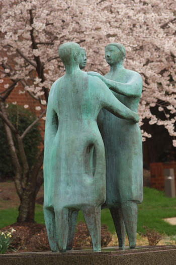 Bronze statue of three people embracing "Communitas" on the campus of Ƶ, Fairfax, VA USA